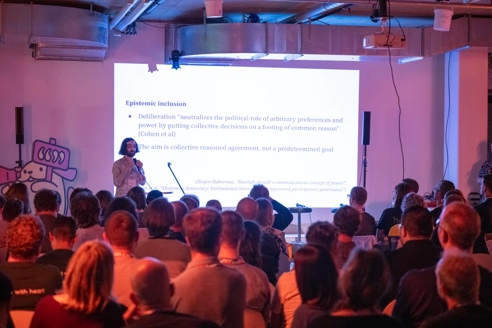 Vlad presenting in front of an audience